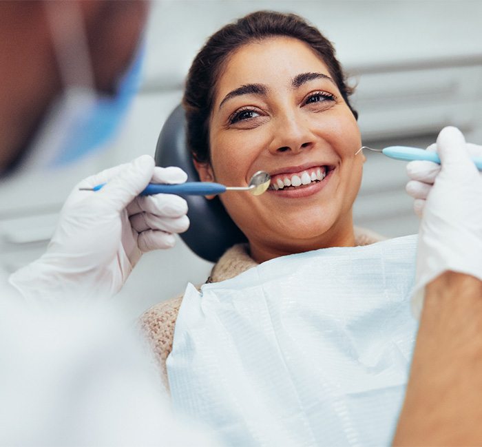 woman having her teeth examined at the dental office